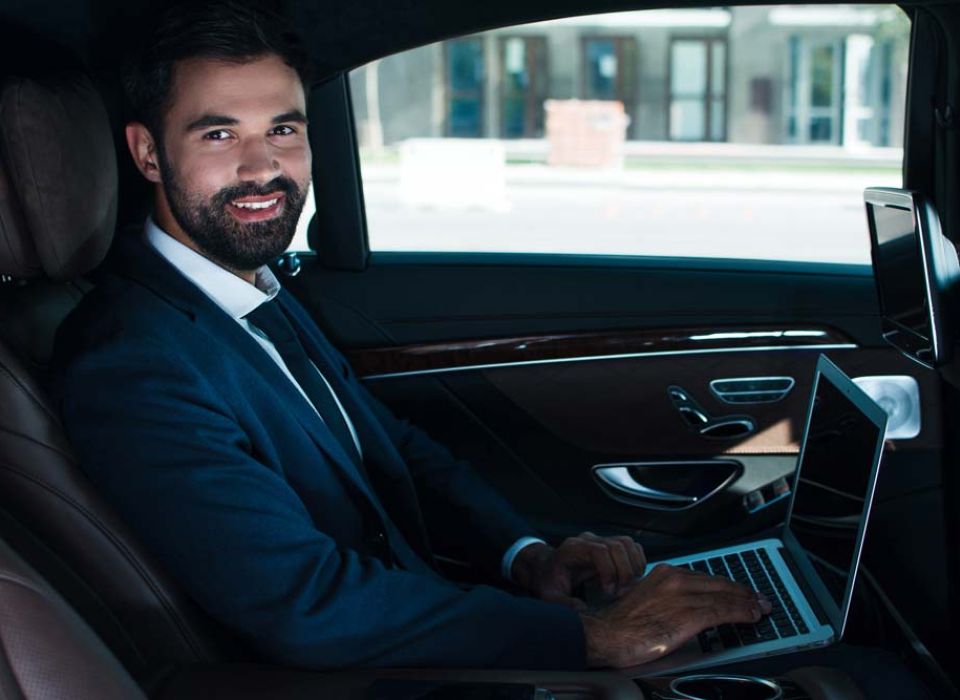 Man working in chauffeured car