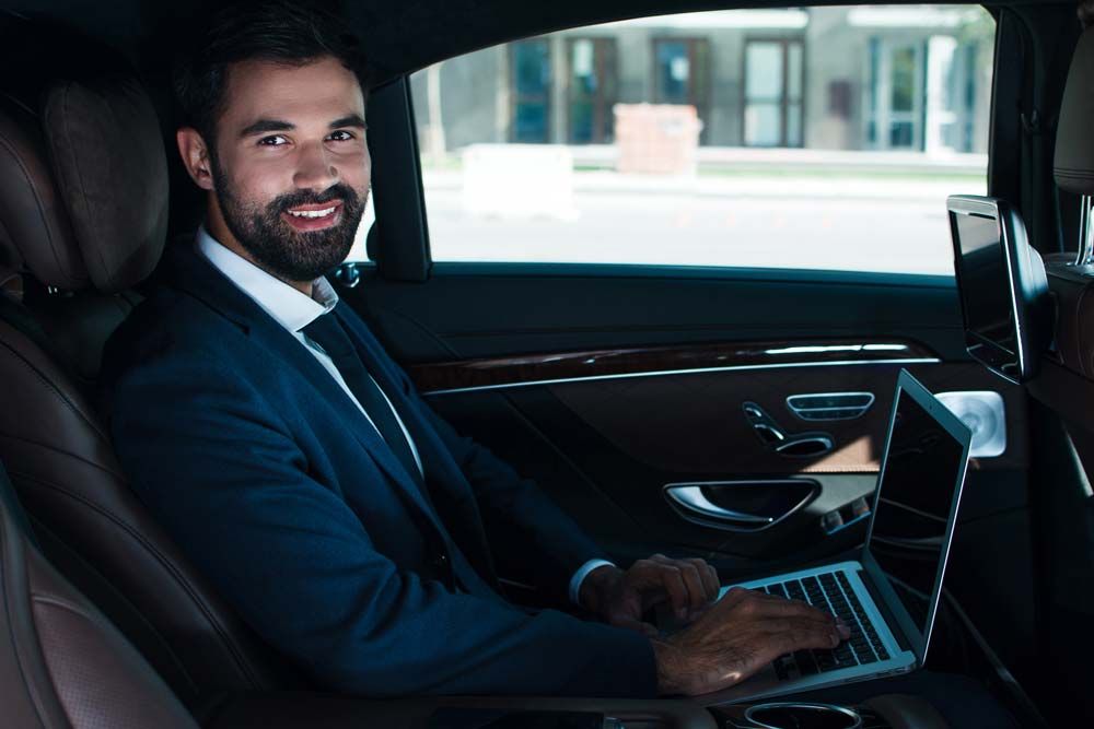 Man working in chauffeured car