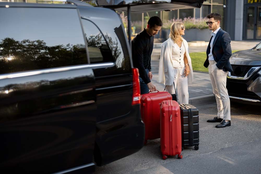 Chauffeur picking up passengers for an airport transfer